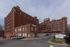 Charming brick loft building with ample windows, offering stylish urban living and convenient parking.