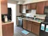 Newly remodeled kitchen with black appliances and dark brown cabinets