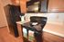 Kitchen with black appliances and light brown cabinets