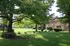 Open grassy area and exterior of brick apartment building