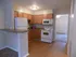 Newly remodeled kitchen with white appliances and light brown cabinets