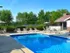 Pool with multiple pool chairs surrounding