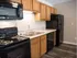 Kitchen with new appliances and decorative tile