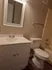 1 bedroom bathroom with light gray vanity and gray VCT flooring