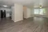 Contemporary open-concept apartment with elegant wood floors, a modern kitchen, and bright, spacious living area.