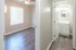 Bright and airy bedroom with elegant wood flooring and a modern bathroom, perfect for a cozy retreat.