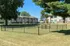 Charming apartment complex surrounded by lush greenery and open spaces, perfect for tranquil living.