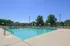 Inviting outdoor swimming pool with surrounding green landscape, perfect for relaxation and leisure.