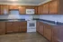 Inviting kitchen with elegant wooden cabinets, modern appliances, and sleek countertops, perfect for culinary creativity.