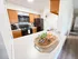 Charming kitchen features modern appliances, rich wood cabinets, and a cozy breakfast bar with stylish decor.