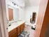 Chic bathroom with modern lighting, elegant vanity, and stylish flooring, offering a serene and refreshing space.