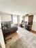 Inviting bedroom with sleek workspace, modern decor, and natural light enhancing the cozy ambiance.