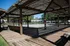 Inviting outdoor patio area with rustic wooden pergolas and bench seating, perfect for relaxation and leisure.