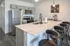 Chic modern kitchen with sleek stainless steel appliances, elegant marble countertops, and stylish bar seating.