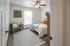 Bright and cozy bedroom with modern decor, featuring a plush bed, stylish armchair, and elegant wall art.