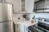 Modern kitchen with sleek stainless steel appliances, elegant marble countertops, and stylish cabinetry creating a sophisticated culinary space.