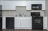 Modern kitchen with sleek white cabinetry, stainless steel appliances, and elegant dark countertops, ideal for culinary enthusiasts.
