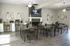 Inviting communal space with modern decor, featuring wooden dining tables, a cozy fireplace, and elegant wall art.