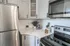 Modern kitchen with stainless steel appliances, elegant marble countertops, and sleek cabinetry.