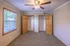 Bright and cozy bedroom with plush carpet, featuring dual closets and large window, perfect for natural light and ample storage.