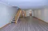 Spacious and inviting open-concept living area with modern wood flooring and elegant recessed lighting, perfect for stylish and comfortable living.