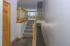 Inviting split-level home entry featuring elegant wooden railings and a spacious, sunlit living area.