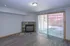 Bright living room featuring a modern fireplace and large sliding glass doors opening to a private patio.