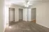 Bright and spacious bedroom with plush carpeting, featuring dual closets and modern ceiling fan for ultimate comfort.