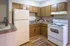 Cozy kitchen with wooden cabinets, modern appliances, and a spacious countertop for culinary creativity.