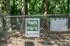 Inviting fenced Bark Park at Shadytree Apartments, nestled in a lush forest setting for pet-friendly living.