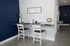 Chic workspace with granite countertop, stylish decor, and inviting chairs against a navy blue accent wall.