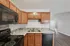 Modern kitchen with sleek cabinetry, elegant backsplash, and stainless steel appliances, offering a stylish culinary space.