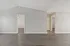Expansive modern living area with sleek hardwood floors, neutral walls, and cozy adjoining rooms, perfect for versatile living.