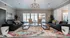 Chic and welcoming living room with large windows, modern lighting, and vibrant decor, offering a perfect blend of comfort and elegance.