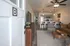 Inviting open-concept apartment with modern kitchen and cozy living area, perfect for relaxation and entertaining.