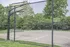Inviting outdoor basketball court surrounded by lush greenery, perfect for recreational activities and community gatherings.