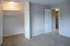 Modern apartment bedroom featuring plush carpet, spacious closet, and a convenient walk-in storage area.