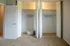 Spacious walk-in closet with neatly arranged hangers and elegant white folding doors, perfect for organized living.
