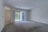 Royal Breeze Apartments Inc, interior, carpeted living room, sliding glass door with blinds to balcony,
