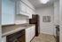 Royal Breeze Apartments Inc, interior, kitchen, white cabinets, black appliances, dishwasher, refrigerator, stove/oven, pass through opening to living room,tile floor