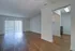 Royal Breeze Apartments Inc, interior, wood floor, living room, dining room, ceiling fan, doorway to bedroom, kitchen, black stove/oven, sliding glass doors with blinds
