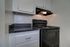 Royal Breeze Apartments Inc, interior, kitchen, white cabinets, black stove/oven