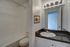 Royal Breeze Apartments Inc, interior, bathroom, large mirror, dark counter, sink, white cabinet, toilet, shower/tub