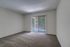 Royal Breeze Apartments Inc, interior, carpeted room, sliding glass doors to balcony with blinds