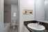 Royal Breeze Apartments Inc, interior, bathroom, white cabinet, dark counter, large mirror, sink, toilet, shower/tub, tile floor
