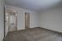Royal Breeze Apartments Inc, interior, carpeted room, two doorways, natural light