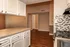 The Avenue Apartments, interior, kitchen, dining room, wood floor, white cabinets, black stove/oven, hallways, closet, breakfast bar counter