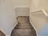 Inviting carpeted staircase with sleek white railings, enhancing modern home aesthetics.