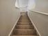 Inviting carpeted stairway with a sleek white railing in a modern home.