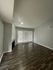 Contemporary living room with elegant hardwood floors, stylish fireplace, and abundant natural light through large windows with blinds.